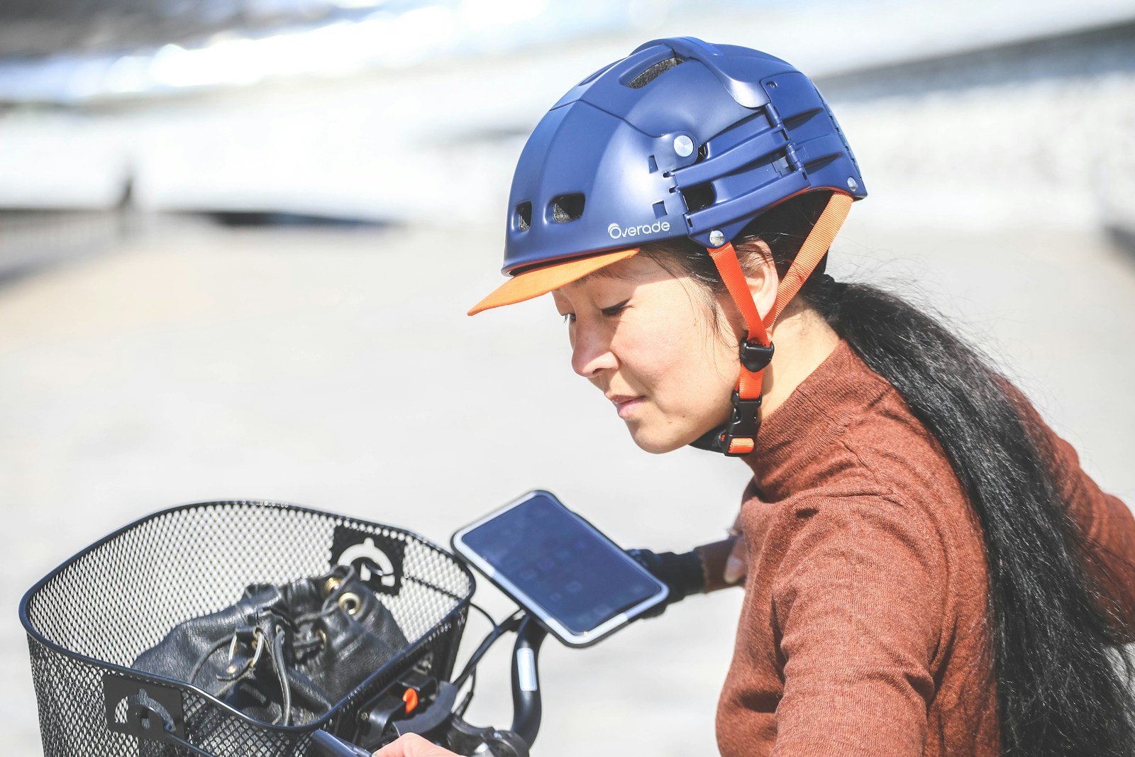 Woman wearing blue helmet with bicycle